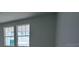 Light-filled bedroom featuring bright walls and two windows at 30155 Rustic Mill Street, Mount Dora, FL 32757