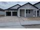 Modern home boasting a two-car garage, attractive brick driveway, and covered porch at 30155 Rustic Mill Street, Mount Dora, FL 32757