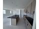 Modern kitchen featuring an island, stylish cabinets, and contemporary black fixtures at 30155 Rustic Mill Street, Mount Dora, FL 32757