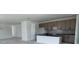 Open concept kitchen with black countertops, stylish cabinets, and modern fixtures at 30155 Rustic Mill Street, Mount Dora, FL 32757