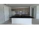 Spacious kitchen featuring an island, stylish cabinets, and sleek black fixtures at 30155 Rustic Mill Street, Mount Dora, FL 32757