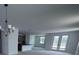 Open living space connecting the kitchen, dining, and living areas with doors leading to the outside at 30155 Rustic Mill Street, Mount Dora, FL 32757
