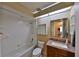 This bathroom includes a tub, toilet, vanity with a granite countertop, and a large mirror above the sink at 309 Panama Cir, Winter Springs, FL 32708