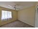 This carpeted bedroom has natural light from a large window, ceiling fan and a closet for storage at 309 Panama Cir, Winter Springs, FL 32708