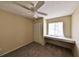 This bedroom features a ceiling fan, a window with an extended sill, and neutral-toned walls and carpet at 309 Panama Cir, Winter Springs, FL 32708