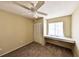 Neutral bedroom features a ceiling fan, closet, and window with a built-in desk at 309 Panama Cir, Winter Springs, FL 32708