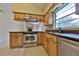 Well-appointed kitchen featuring stainless steel appliances, wood cabinets, and granite countertops at 309 Panama Cir, Winter Springs, FL 32708