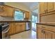 Functional kitchen featuring stainless steel appliances, wood cabinetry, and a view of the backyard at 309 Panama Cir, Winter Springs, FL 32708