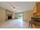 Inviting living room featuring a brick fireplace, tile flooring, and sliding glass doors to backyard at 309 Panama Cir, Winter Springs, FL 32708