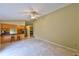 Open-concept living area featuring tile flooring, a ceiling fan, and a breakfast bar with barstool seating at 309 Panama Cir, Winter Springs, FL 32708