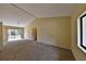 Spacious living room with neutral carpet and a sliding glass door providing ample natural light at 309 Panama Cir, Winter Springs, FL 32708