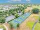 Aerial shot of the community's tennis and pickleball courts, near parking, and scenic walking paths at 3149 Songbird Cir, Harmony, FL 34773