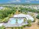 Aerial view of the clubhouse and pool amidst lush landscaping and nearby community at 3149 Songbird Cir, Harmony, FL 34773