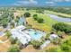 Stunning aerial view of the community pool, golf course and tennis courts at 3149 Songbird Cir, Harmony, FL 34773
