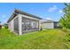 Spacious backyard featuring green grass, and a view of the home's screened-in porch at 3149 Songbird Cir, Harmony, FL 34773