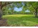 Lush green space featuring mature trees and beautiful landscaping, offering a serene environment at 3149 Songbird Cir, Harmony, FL 34773