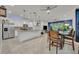 Modern kitchen with stainless steel appliances, kitchen island, neutral countertops, and tiled flooring at 3149 Songbird Cir, Harmony, FL 34773