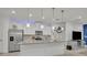Modern kitchen with stainless steel appliances, gray countertops, recessed lighting, island, and tile flooring at 3149 Songbird Cir, Harmony, FL 34773