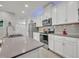 Bright kitchen featuring white cabinets, stainless steel appliances, and island at 3149 Songbird Cir, Harmony, FL 34773