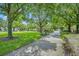 A beautiful walkway meanders through a park-like setting with benches and lush landscaping at 3149 Songbird Cir, Harmony, FL 34773