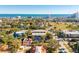 Expansive aerial view capturing a coastal neighborhood with lush trees and the ocean in the distance at 315 Glenview Blvd # 3, Daytona Beach, FL 32118