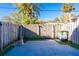 This fenced-in backyard includes a concrete patio with palm trees in view at 315 Glenview Blvd # 3, Daytona Beach, FL 32118