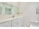 Bright bathroom featuring white cabinets, a large mirror, and a sink at 315 Glenview Blvd # 3, Daytona Beach, FL 32118