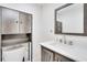 Well-lit bathroom with white countertop, gray vanity, modern fixtures, mirror, and additional storage space above the toilet at 315 Glenview Blvd # 3, Daytona Beach, FL 32118