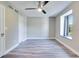 This spacious bedroom features wood floors, a ceiling fan, and a bright window with curtains at 315 Glenview Blvd # 3, Daytona Beach, FL 32118