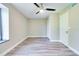 Neutral bedroom featuring modern wood floors, a ceiling fan, window with curtains, and base trim at 315 Glenview Blvd # 3, Daytona Beach, FL 32118