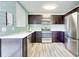 Modern kitchen featuring stainless steel appliances, dark cabinets, tiled backsplash, and a stainless steel refrigerator at 315 Glenview Blvd # 3, Daytona Beach, FL 32118