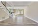 Bright living room with wood-look floors, staircase with white railings and black trim, and a view to the exterior at 315 Glenview Blvd # 3, Daytona Beach, FL 32118