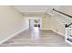 Bright living room features modern flooring, staircase with black and white trim, and sliding glass doors to the outside at 315 Glenview Blvd # 3, Daytona Beach, FL 32118