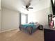 Cozy bedroom featuring carpeted floors and a window that provides natural light at 318 Briarbrook Ln, Haines City, FL 33844