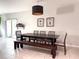 Dining room with a dark wood table and contemporary chandelier with convenient access to the backyard at 318 Briarbrook Ln, Haines City, FL 33844