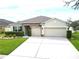 Charming single-Gathering home featuring a well-manicured lawn and a spacious three-car garage at 318 Briarbrook Ln, Haines City, FL 33844
