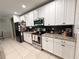 Modern kitchen featuring stainless steel appliances, granite countertops, and ample white cabinetry at 318 Briarbrook Ln, Haines City, FL 33844