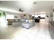 Spacious open-concept living room featuring tiled floors that flow into the kitchen at 318 Briarbrook Ln, Haines City, FL 33844