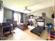 Spacious living room features neutral tile flooring, large windows and ceiling fan at 318 Briarbrook Ln, Haines City, FL 33844