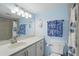 Bright bathroom with blue coastal accents, white vanity, and shower/tub combo at 3180 Ocean Shore Blvd # 407, Ormond Beach, FL 32176