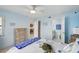 Inviting bedroom with coastal decor, ceiling fan, and en-suite bathroom access at 3180 Ocean Shore Blvd # 407, Ormond Beach, FL 32176