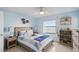 Cozy bedroom with coastal decor, ceiling fan, and ocean view at 3180 Ocean Shore Blvd # 407, Ormond Beach, FL 32176