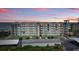 Beautiful exterior view of condo building with meticulously manicured grounds at 3180 Ocean Shore Blvd # 407, Ormond Beach, FL 32176