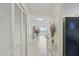 Bright hallway features tile flooring and a view to the ocean, leading to the living area and bedrooms at 3180 Ocean Shore Blvd # 407, Ormond Beach, FL 32176