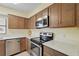 Bright kitchen with stainless steel appliances, solid surface counters, and ample cabinet space at 3180 Ocean Shore Blvd # 407, Ormond Beach, FL 32176