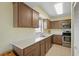 Updated kitchen with stainless steel appliances, bright white countertop and window view at 3180 Ocean Shore Blvd # 407, Ormond Beach, FL 32176