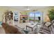 Cozy living room with view to ocean through the sliding glass door to the balcony and adjacent bedroom at 3180 Ocean Shore Blvd # 407, Ormond Beach, FL 32176