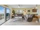 Inviting living room with beach-themed decor, comfortable seating, and large sliding glass door access to an ocean view balcony at 3180 Ocean Shore Blvd # 407, Ormond Beach, FL 32176