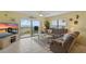 Cozy living room features a sliding glass door to the balcony with breathtaking ocean views and comfortable seating at 3180 Ocean Shore Blvd # 407, Ormond Beach, FL 32176