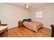 Cozy bedroom with hardwood floors, a comfortable bed, and a ceiling fan creating a relaxing retreat at 320 Lakeview St # 208, Orlando, FL 32804